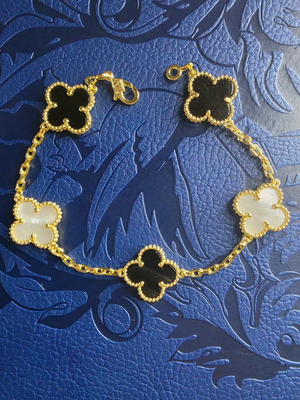 Yves Saint Laurent Gold Clover Bracelet with Black and White Motifs